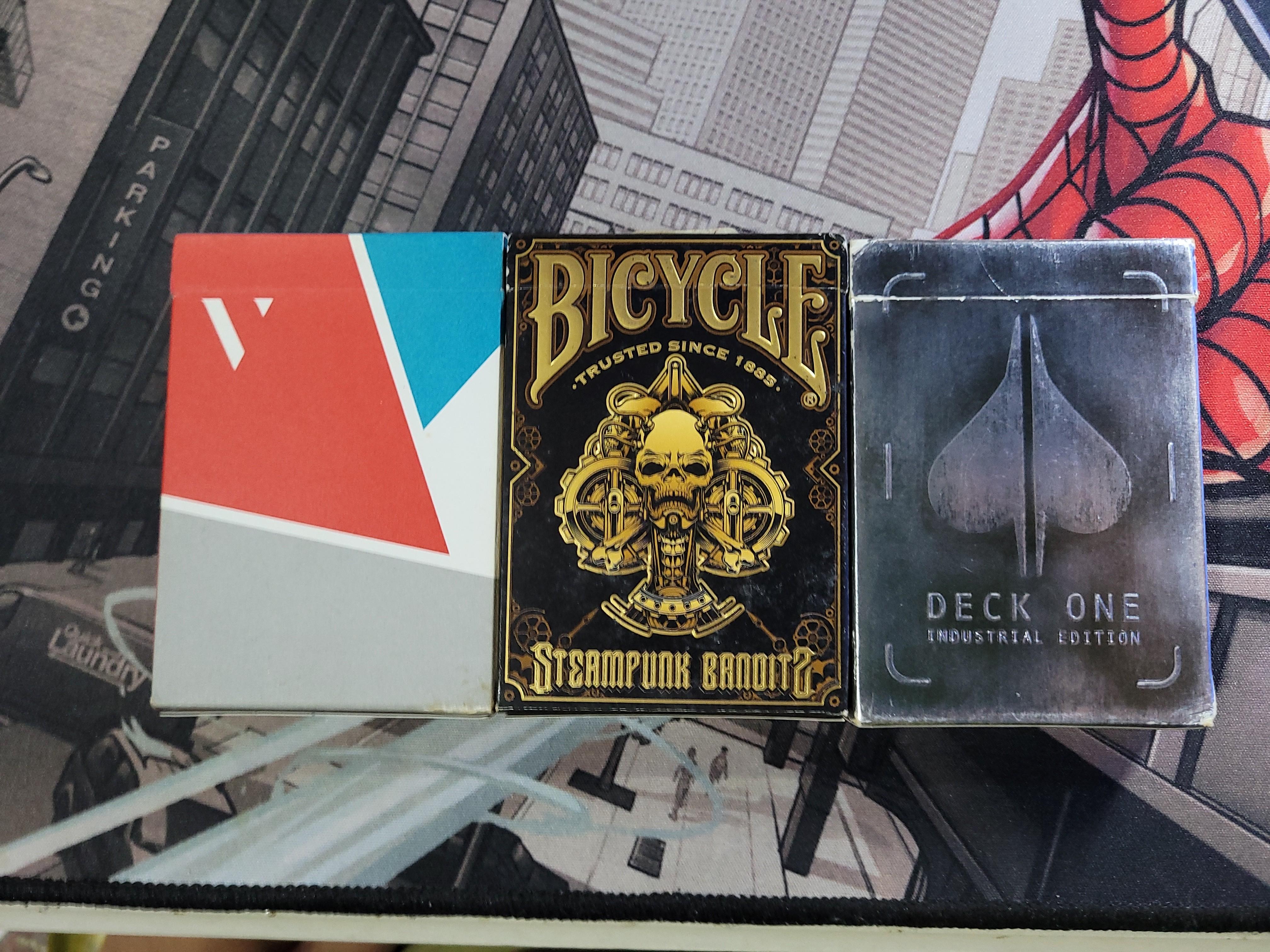 Assorted playing cards (Category: Interactive Toys) located in Singapore. Submitted by muhdhaiqal1121 (Listing ID 1049385653, Image 3). Description: Assorted playing cards for sale. Brand New (Unsealed) - BICYCLE STEAMPUNK (signed by Asad of 52Kards) - $20 Brand New (Sealed) - TITAN - $15 - BICYCLE SKULL & BONES BACK - $12 - BICYCLE DRAGON BACK - $12 - DECK ONE - $12 Opened and used - VIRTUOSO (SOLD) - DECK ONE - $5 - BICYCLE STEAMPUNK BANDITS - 