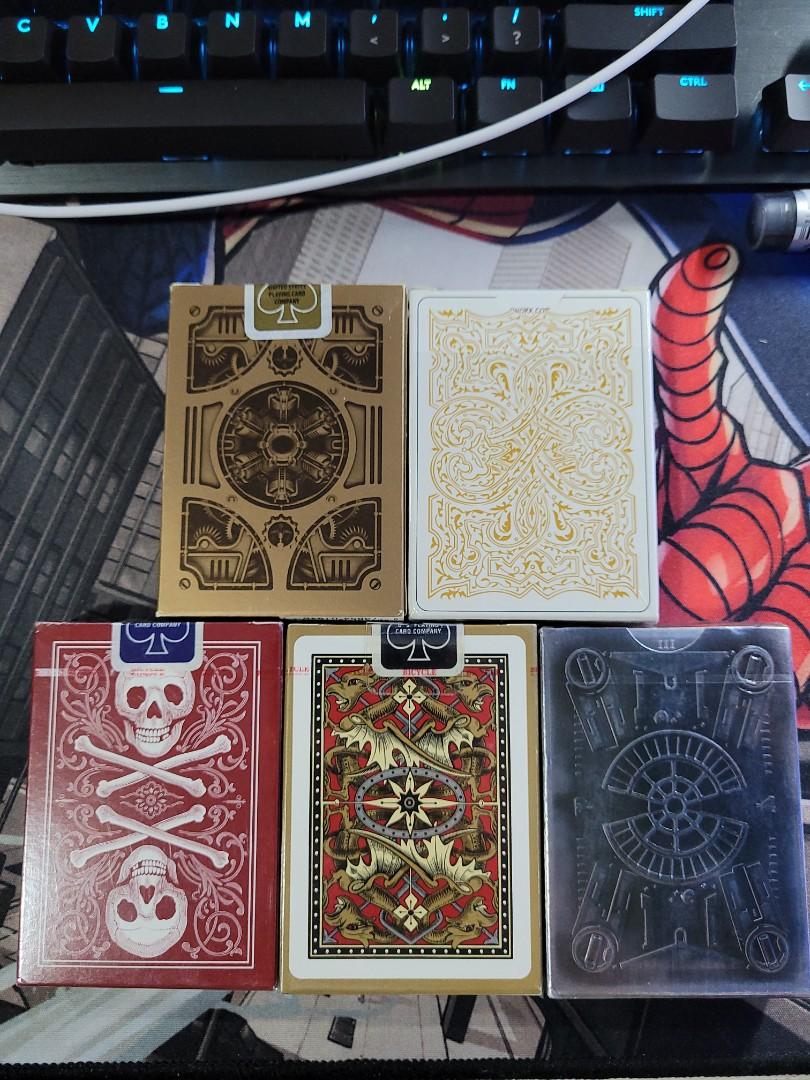Assorted playing cards (Category: Interactive Toys) located in Singapore. Submitted by muhdhaiqal1121 (Listing ID 1049385653, Image 2). Description: Assorted playing cards for sale. Brand New (Unsealed) - BICYCLE STEAMPUNK (signed by Asad of 52Kards) - $20 Brand New (Sealed) - TITAN - $15 - BICYCLE SKULL & BONES BACK - $12 - BICYCLE DRAGON BACK - $12 - DECK ONE - $12 Opened and used - VIRTUOSO (SOLD) - DECK ONE - $5 - BICYCLE STEAMPUNK BANDITS - 