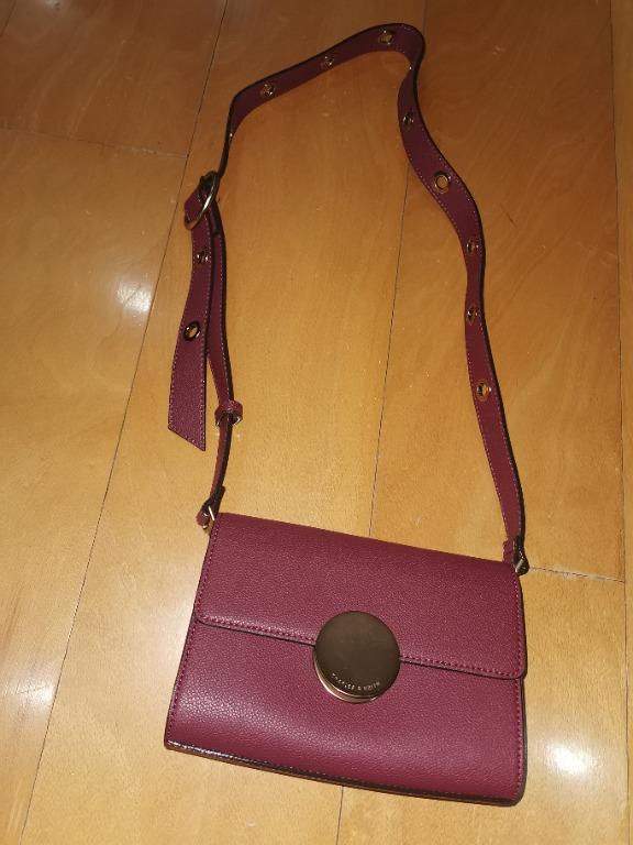 Charles Keith prune plum maroon leather crossbody sling bag with eyelet strap detail and gold accent hardware