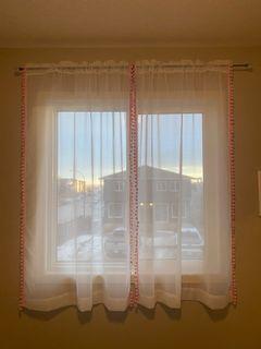 Pink pompon curtains with black diamond rod