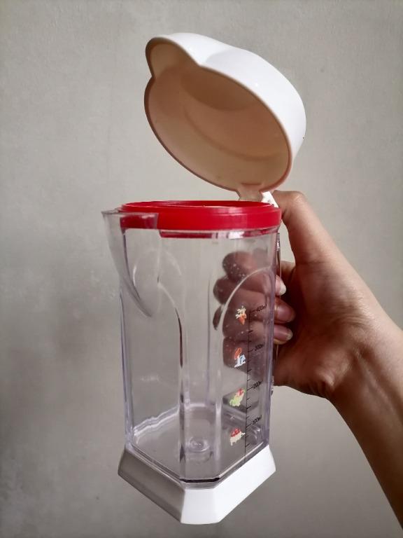 Measuring Cup/ Condiments Container/ Pitcher (Medium) (Category: Other Kitchenware & Tableware) located in San Mateo. Submitted by Babyfume (Listing ID 1047009896, Image 3). Description: BOUGHT IN THE MIDDLE EAST A clear transparent plastic container with cover and removable stopper used as a measuring cup or condiments container can also be a beverage pitcher for smoothies and shakes, blender style design accurate measuring container best used f
