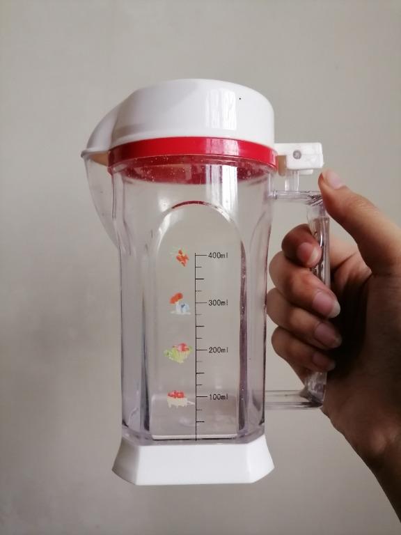 Measuring Cup/ Condiments Container/ Pitcher (Medium) (Category: Other Kitchenware & Tableware) located in San Mateo. Submitted by Babyfume (Listing ID 1047009896, Image 1). Description: BOUGHT IN THE MIDDLE EAST A clear transparent plastic container with cover and removable stopper used as a measuring cup or condiments container can also be a beverage pitcher for smoothies and shakes, blender style design accurate measuring container best used f