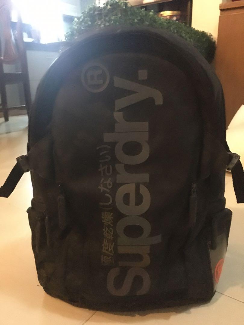 Superdry black backpack (Category: Backpacks) located in Muntinlupa City. Submitted by phrque (Listing ID 1055785585, Image 1). Description: With minimal scratches. Not visible. With lots of compartments. Good for traveling. .