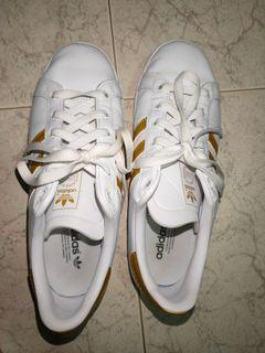 adidas white shoes with gold stripes
