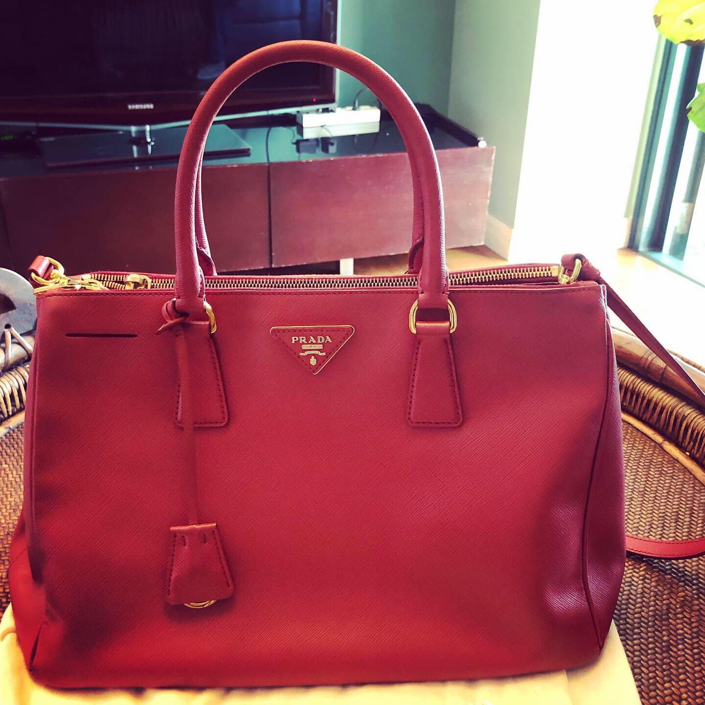 Authentic Prada Saffiano red lucky bag🧧 (Category: Luxury Bags & Wallets) located in Makati City. Submitted by abygi88 (Listing ID 1053978488, Image 2). Description: Adjustable detachable long strapis very clean. exterior leather is clean and still fresh interior lining is clean w/ no wear present. Gold-tone hardware Lux textured leather double zip tote bought in Europe used 5x only excellent conditon 📍Wear it across your chest or tote it on th