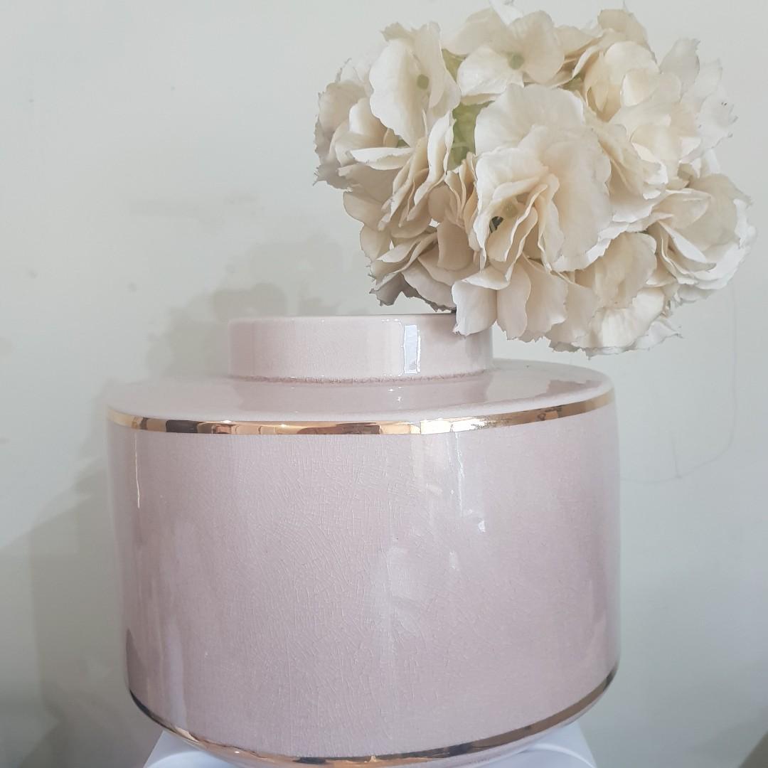 H&M blush pink jar vase (Category: Laundry Baskets) located in Taguig. Submitted by shopsaleph (Listing ID 1053581523, Image 1). Description: H&M blush pink nude with gold accent vase jar. P1100. Like new condition. There is a small gold missing on the line but it was really like that when bought. Inside vase just needs a little cleaning. Bought for P1490. Flower not included..