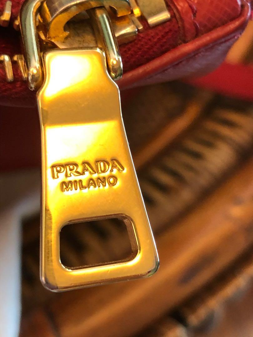 Authentic Prada Saffiano red lucky bag🧧 (Category: Luxury Bags & Wallets) located in Makati City. Submitted by abygi88 (Listing ID 1053978488, Image 3). Description: Adjustable detachable long strapis very clean. exterior leather is clean and still fresh interior lining is clean w/ no wear present. Gold-tone hardware Lux textured leather double zip tote bought in Europe used 5x only excellent conditon 📍Wear it across your chest or tote it on th