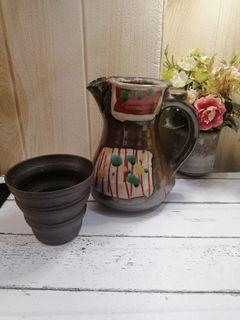 Stoneware pitcher with teacup