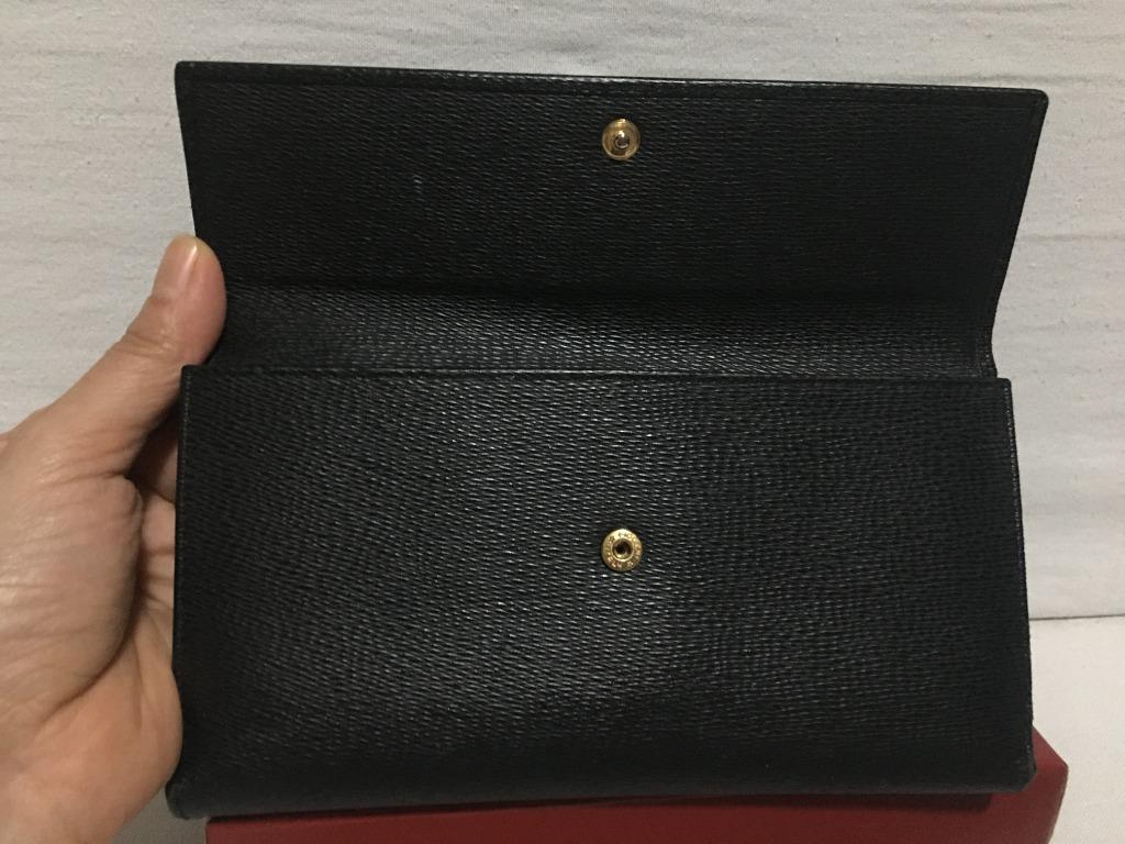 Salvatore Ferragamo Long Flap wallet (Category: Luxury Bags & Wallets) located in Quezon City. Submitted by limebasil (Listing ID 1054327704, Image 3). Description: Brand: Salvatore Ferragamo Guaranteed Authentic item or money back. Material: Leather Condition: 8/10; With light scuffing on the side and hardware 6 card slots; 2 inner pockets; 1 outer pocket for bills or coins Comes with box and card .