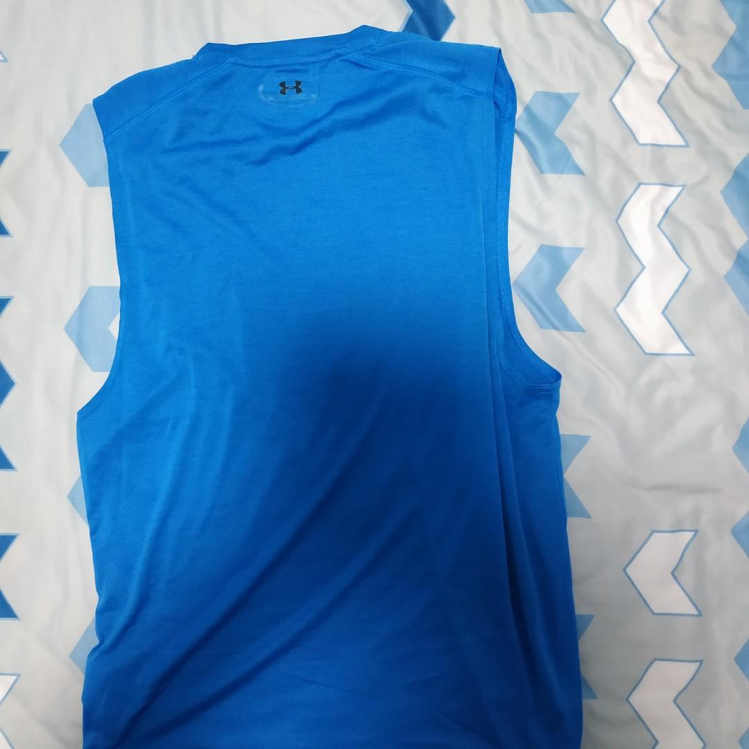 Under Armour Singlets (Category: Tshirts & Polo Shirts) located in Singapore. Submitted by storm12 (Listing ID 1001271307, Image 2). Description: Hello! This listing is for a set of Under Armour singlets. For the grey one, it's size is S and the icon has faded completely and for the blue one, it's size is M and the icon is slightly faded. Overall, besides the logo, they are still in very good condition. Prefers to meet in the east. I.e. Pasir Ris