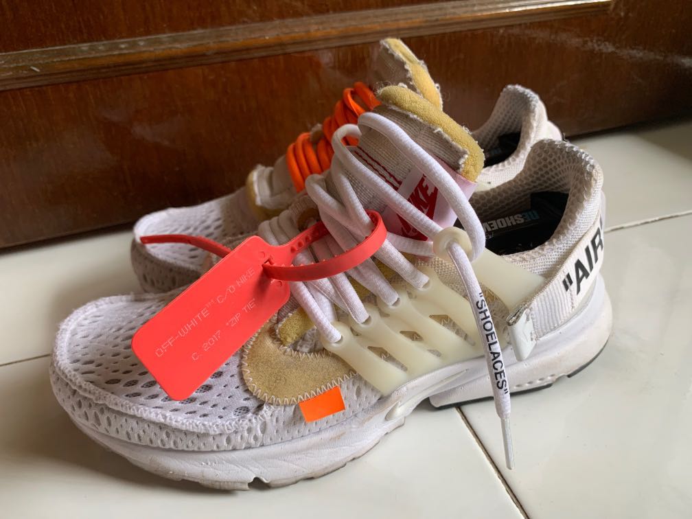 white nike shoes with red check