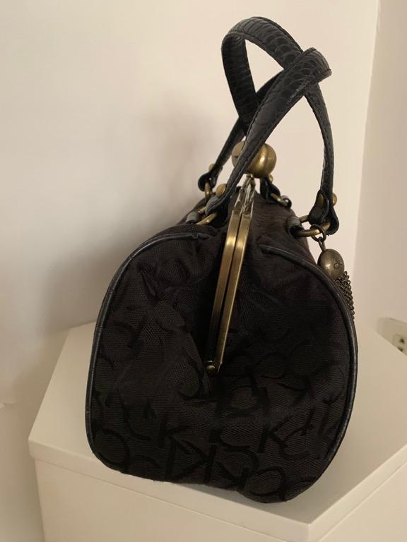 CK doctors bag (Category: Luxury Bags & Wallets) located in Mandaluyong City. Submitted by jeunefille168 (Listing ID 1002390008, Image 2). Description: second hand authentic calvin klein doctors bag in black ck logo canvas with gold-tone hardware, kiss-lock closure & tassel bag charm dual flat strap, interior pocket with zipper & cellphone slot includes dust bag purchased in CK greenbelt shipping for the account of the buyer payment options: bpi,