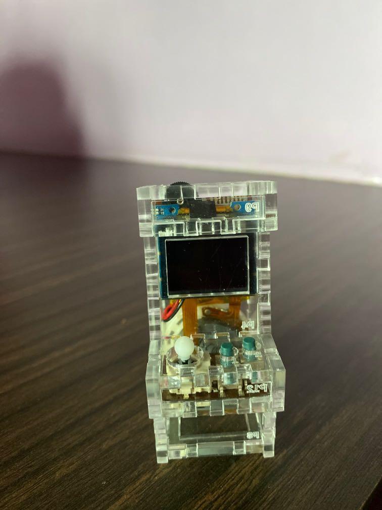Tiny Arcade (Category: Interactive Toys) located in Singapore. Submitted by nutttttttt (Listing ID 1006034525, Image 1). Description: Tiny arcade from Kickstarter. Battery can be charged using usb. For more information: https://www.kickstarter.com/projects/kenburns/tiny-arcade-a-retro-tiny-playable-game-cabinet.
