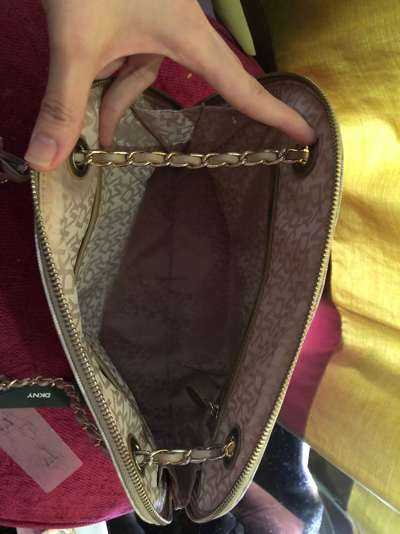 Authentic DKNY Handbag ✨ (Category: Tote Bags) located in Mandaluyong City. Submitted by cambeeb (Listing ID 1007385420, Image 3). Description: DKNY Handbag ✨ -NEVER been used (Good as new) -With tags and covered zipper -Can be worn as shoulder bag or sling bag -Color: Hemp-LT-chino -Bought it for: $ 185 (9,300 pesos) -Selling for P 2500 + sf R.S. Decluttering Don’t hesitate to message me for questions. 😊.