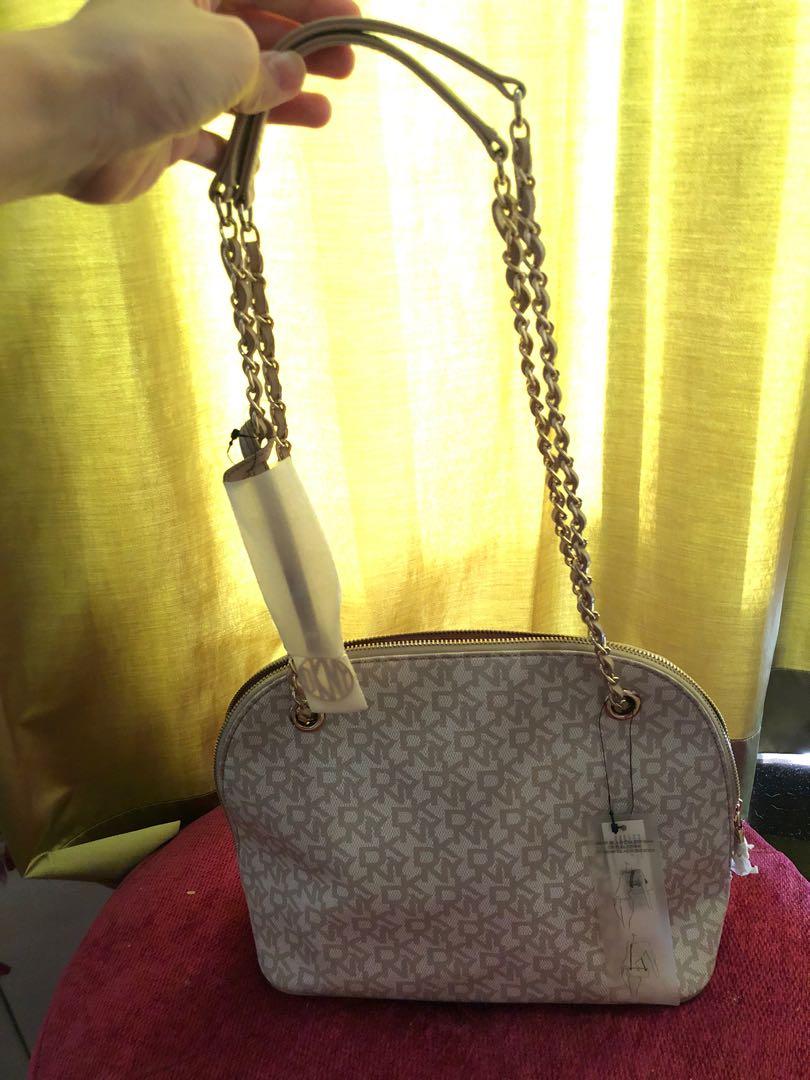 Authentic DKNY Handbag ✨ (Category: Tote Bags) located in Mandaluyong City. Submitted by cambeeb (Listing ID 1007385420, Image 2). Description: DKNY Handbag ✨ -NEVER been used (Good as new) -With tags and covered zipper -Can be worn as shoulder bag or sling bag -Color: Hemp-LT-chino -Bought it for: $ 185 (9,300 pesos) -Selling for P 2500 + sf R.S. Decluttering Don’t hesitate to message me for questions. 😊.