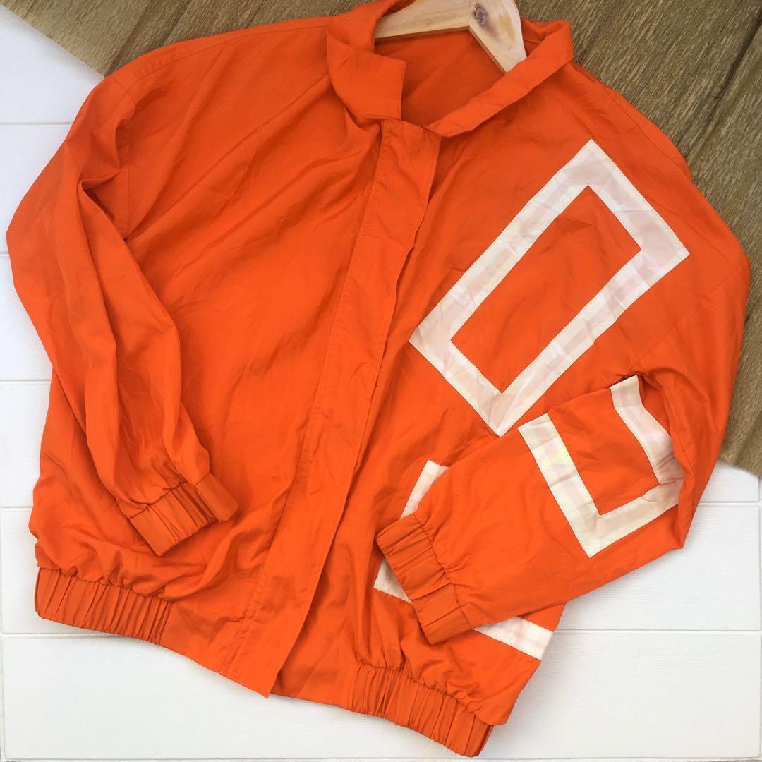 Orange jacket with plastic-like accent 