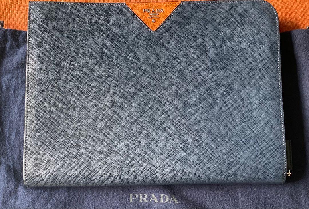 Prada Document Laptop Bag / Clutch - Authentic Mens (Category: Bags & Wallets) located in Singapore. Submitted by ruban.bleu (Listing ID 1010128190, Image 2). Description: REDUCED! Prada Saffiano Leather Document Holder, rare dark blue with orange accent. Only lightly used 3 times briefly, in excellent condition (occasional superficial marks externally). Comes with dust bag and original warranty card. Purchased from Prada MBS May 2018. 33x24cm. N