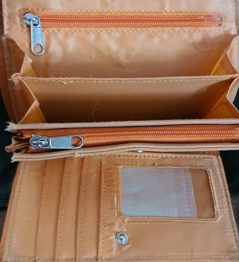 Original MONTENAPOLEONE Milano Wallet (Category: Wallets & Card holders) located in San Pedro. Submitted by czars (Listing ID 1004251740, Image 3). Description: An original Montenapoleone Milano wallet in tangerine color with several card slots . Magnetic snaps and zippers are working perfectly. This was originally bought in New Zealand. issue: with slight damage (see last photo) some penmarks (but might be removed with bleaching solutions) signs