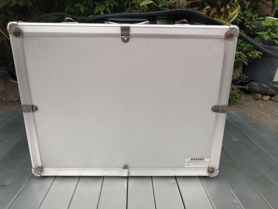 Hakuba Aluminum Camera Case (Category: Camera Bags & Carriers) located in Manila. Submitted by benjie.benjie3 (Listing ID 1004545696, Image 1). Description: Hakuba aluminum camera case H= 13 inches L= 16 1/2 inches W= 7 Inches Material = aluminum and metal W division no key Made in = Tokyo Japan 2nd hand with scratch No warranty Damage=Issues or damaged part of the item can be seen in the last picture Price = 3,000 No swapping please. Price does 