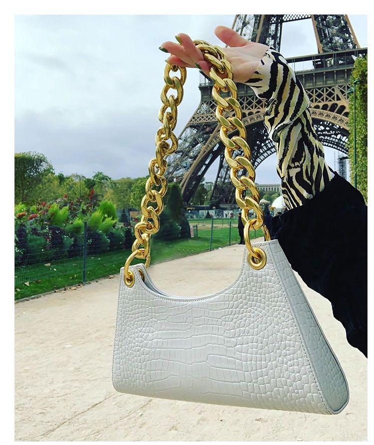 white handbag with gold chain