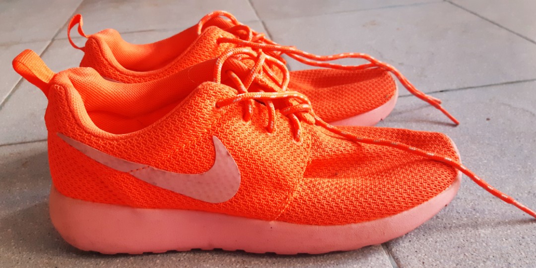 red and orange nike shoes