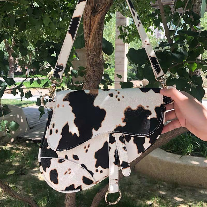 Cow print saddle bag discount