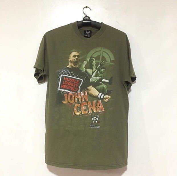 Vintage WWE John Cena Shirt (Category: Community) located in Quezon City. Submitted by emporium.vtg (Listing ID 1014975379, Image 1). Description: Vintage John Cena Hustle Loyalty and Respect Mega Print Wrestling Tee . Size M Length: 28.5” Width: 19.5” Issue: small pinhole.