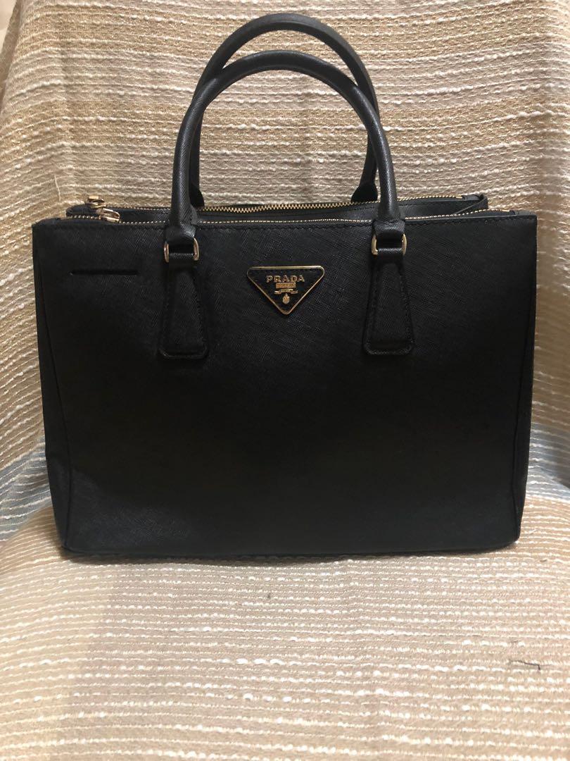 saffiano tote/handbag (Category: Luxury Bags & Wallets) located in Manila. Submitted by edifier888 (Listing ID 1015449405, Image 1). Description: In good condition, hardwares are 95% in good condition with slight scratch in the right hand part of the bag.