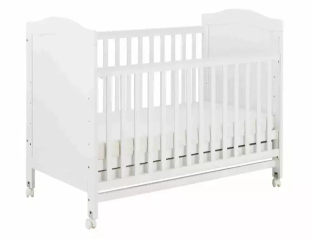 white and wood baby crib