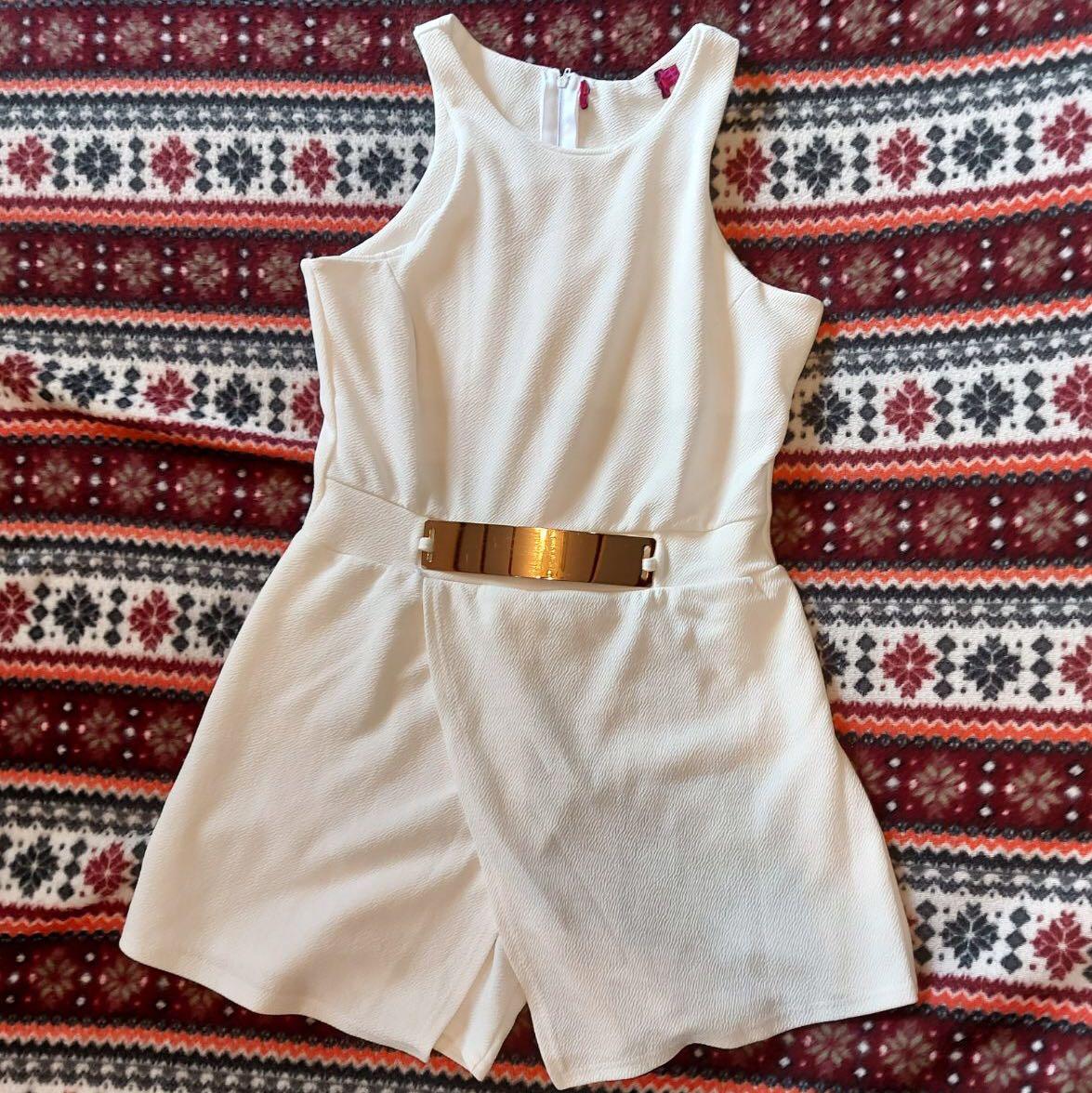 white jumpsuit with gold belt