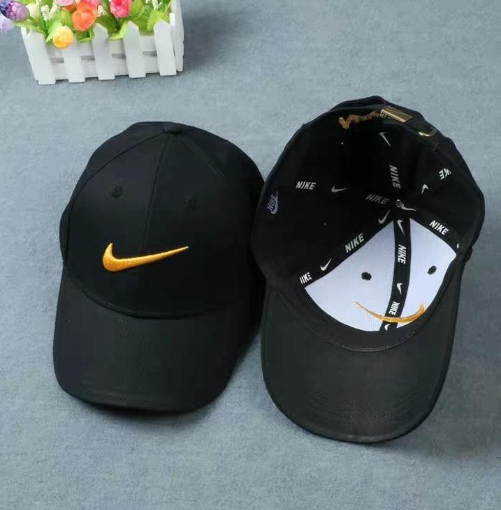 black nike with gold swoosh