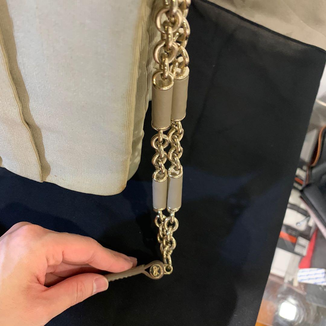 Anya Hindmarch Gracie Bag (Category: Bags & Wallets) located in Singapore. Submitted by jly55 (Listing ID 1011352542, Image 3). Description: Anya Hindmarch Gracie bag in grey fabric and leather chain The bag has pleating down the front and features include a leather and chain handle and an Anya Hindmarch signature bow on the front of the bag near the base. The Gracie is a flapover style bag and fastens with branded turn lock fastening. Inside, th