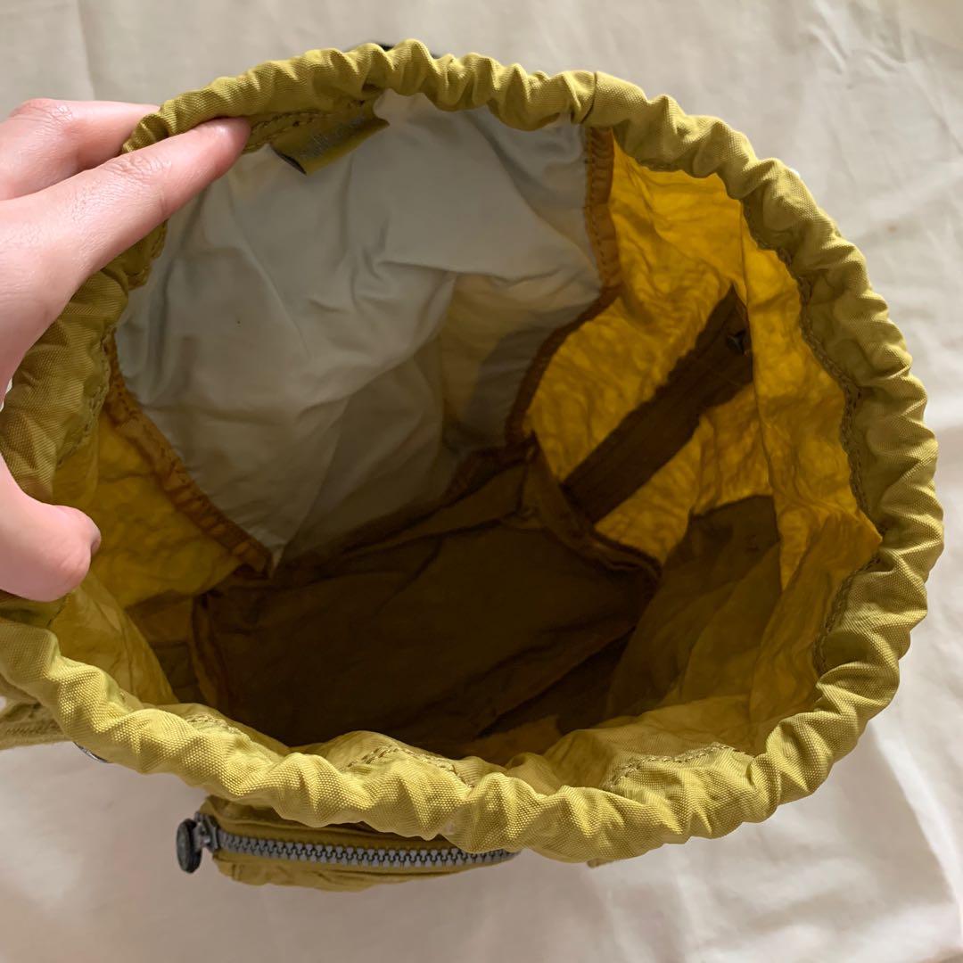 Kipling Green Drawstring Backpack (Category: Backpacks) located in Singapore. Submitted by bubblewrapped (Listing ID 1011474235, Image 3). Description: Authentic small Kipling backpack - 28cm width - 38cm height Waterproof material Condition: 10/10 .