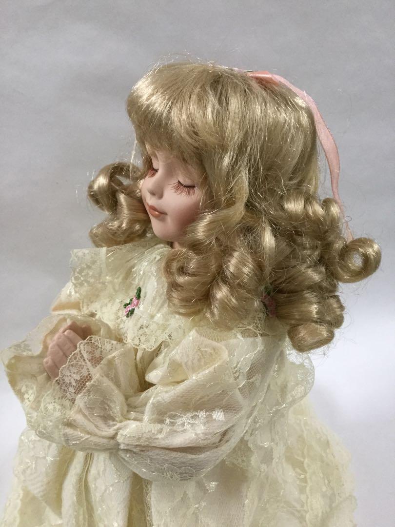 praying porcelain doll