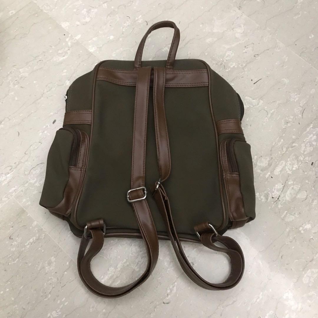 Brown Backpack (Category: Backpacks) located in Singapore. Submitted by flyingpigss (Listing ID 1012420732, Image 2). Description: Very cute piece🌷 Condition 8/10✨ Strings on the straps cane off but can be cut away🌿.