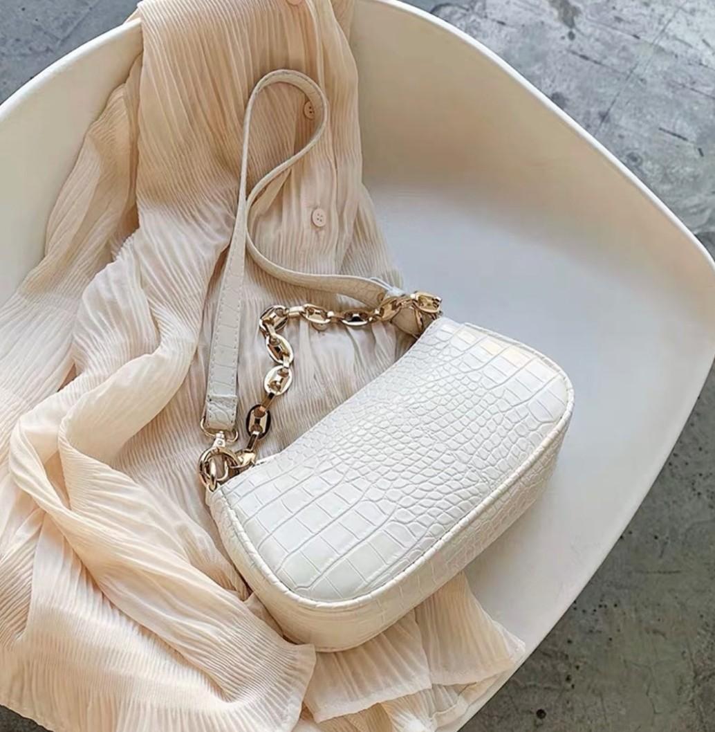 white handbag with gold chain