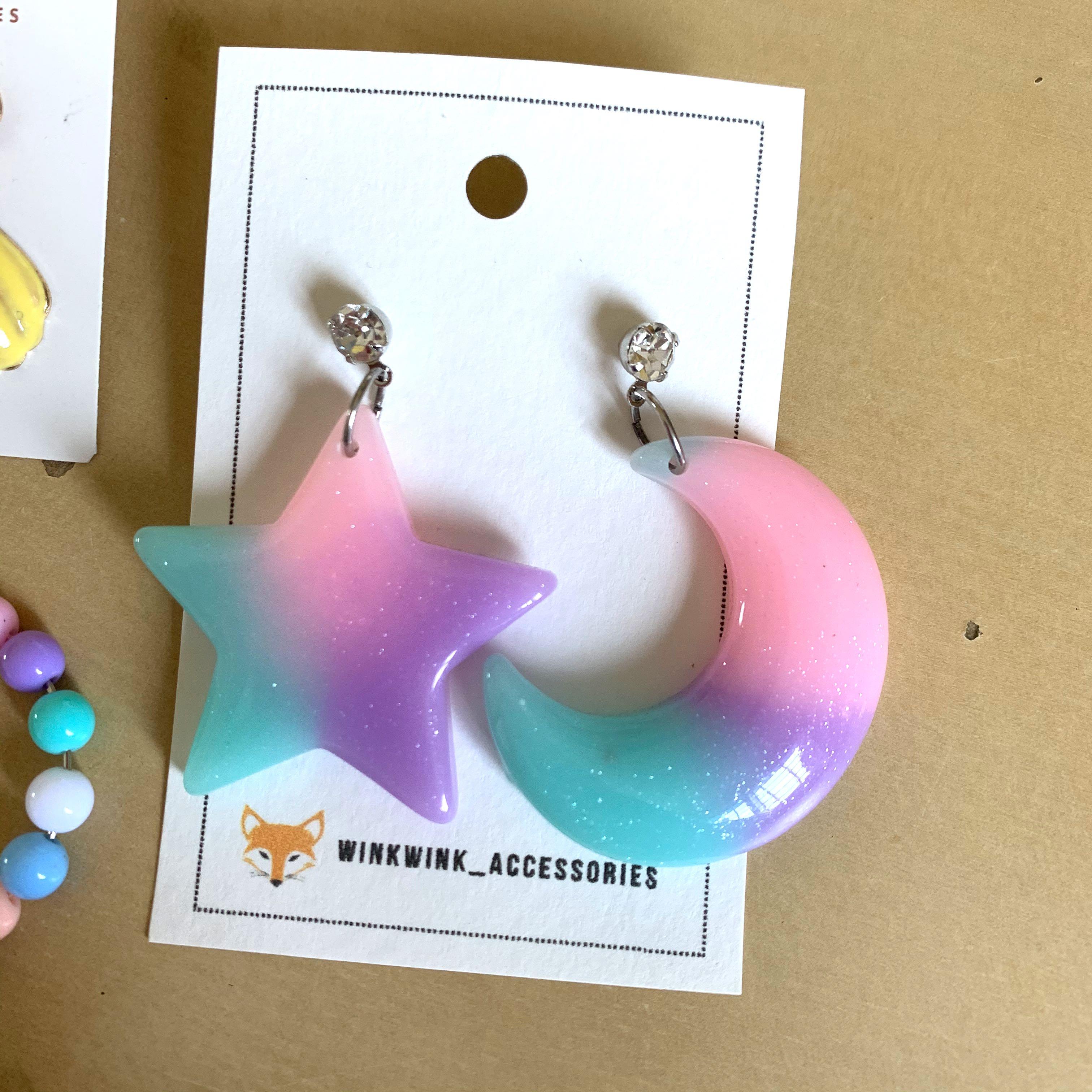 assorted earrings (Category: Earrings) located in Singapore. Submitted by chloeeeee_ (Listing ID 1017688542, Image 2). Description: hi! i’m selling away 3 pairs of brand new & not worned earrings!! do scroll through all the pictures to have a close-up look at each pair ((-: colourful/pastel star & moon earring (2nd pic): $5 mailed pastel beads earring (3rd pic): $4 mailed **shell earring (4th pic): $2.50 mailed **naturally comes with the blackish