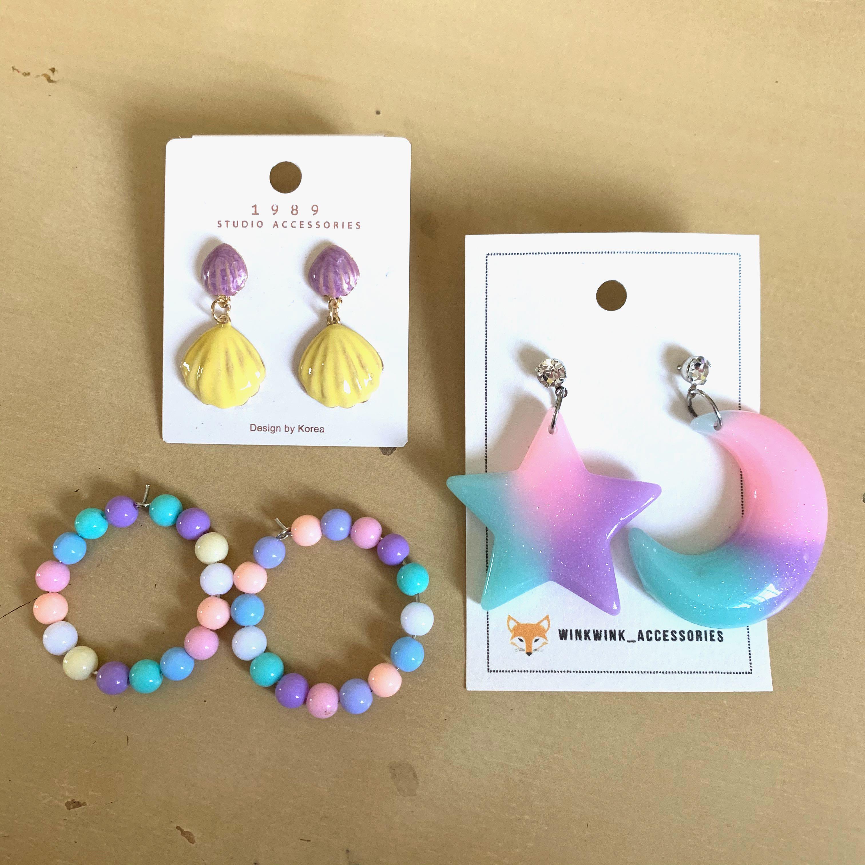 assorted earrings (Category: Earrings) located in Singapore. Submitted by chloeeeee_ (Listing ID 1017688542, Image 1). Description: hi! i’m selling away 3 pairs of brand new & not worned earrings!! do scroll through all the pictures to have a close-up look at each pair ((-: colourful/pastel star & moon earring (2nd pic): $5 mailed pastel beads earring (3rd pic): $4 mailed **shell earring (4th pic): $2.50 mailed **naturally comes with the blackish
