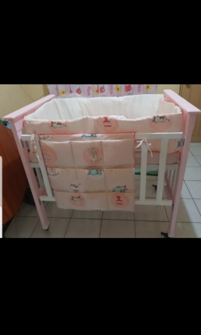 pink crib with changing table