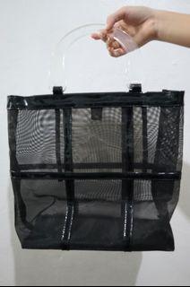 See-through black handbag with clear handles