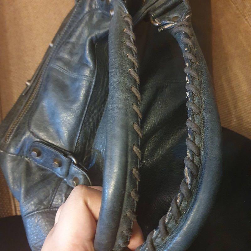 Authentic Balenciaga Bag (Category: Luxury Bags & Wallets) located in Pasig City. Submitted by sibsmnl (Listing ID 1023574684, Image 3). Description: * 100% authentic or your money back * Comes with mirror * Rating: 7.5 out of 10 * No major flaws, just signs of use * I’m not so familiar with the model, but this doesn’t have a strap * Distressed lambskin, not because of use, it’s just the design :) * Hardware is a little dirty, but a little cleani