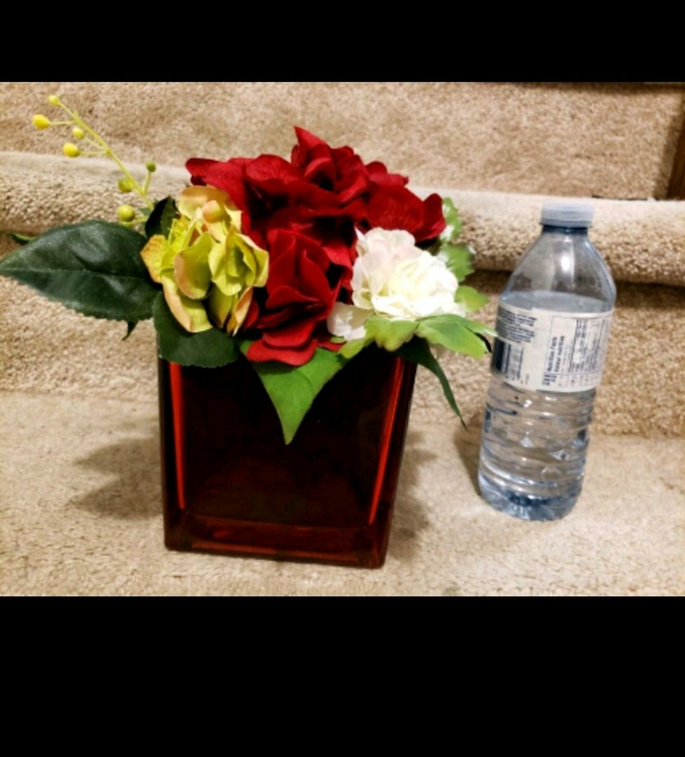 Red vase with floral arrangement