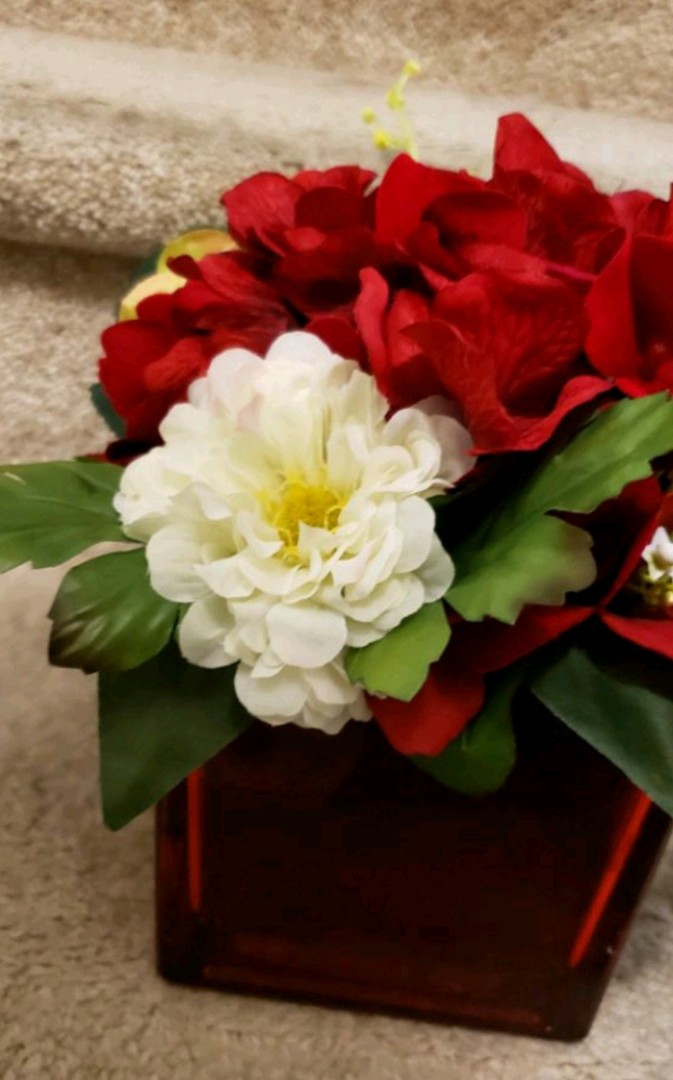 Red vase with floral arrangement