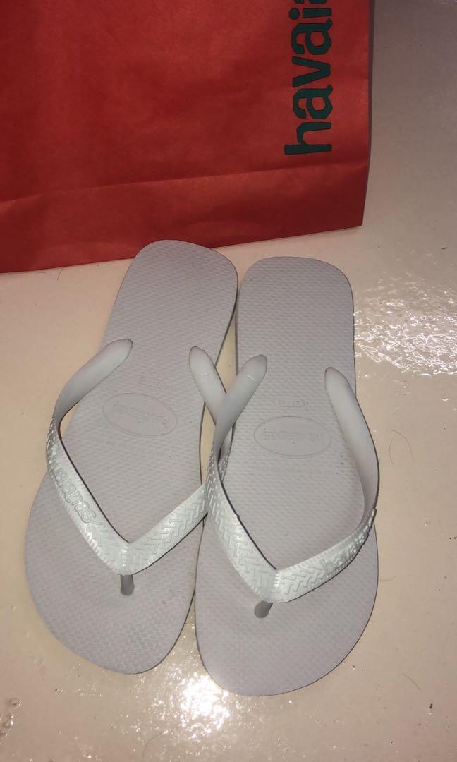 white and silver flip flops