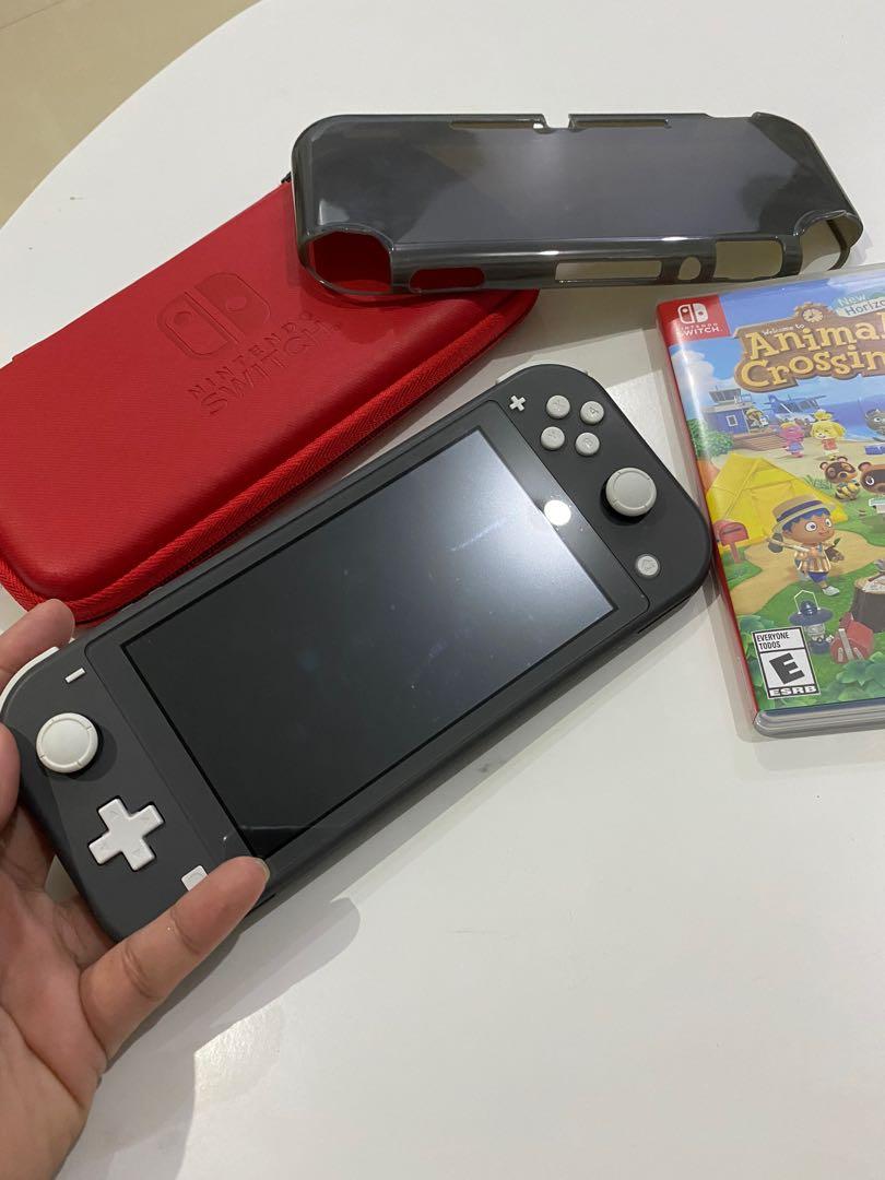 nintendo switch lite with animal crossing game and accessories