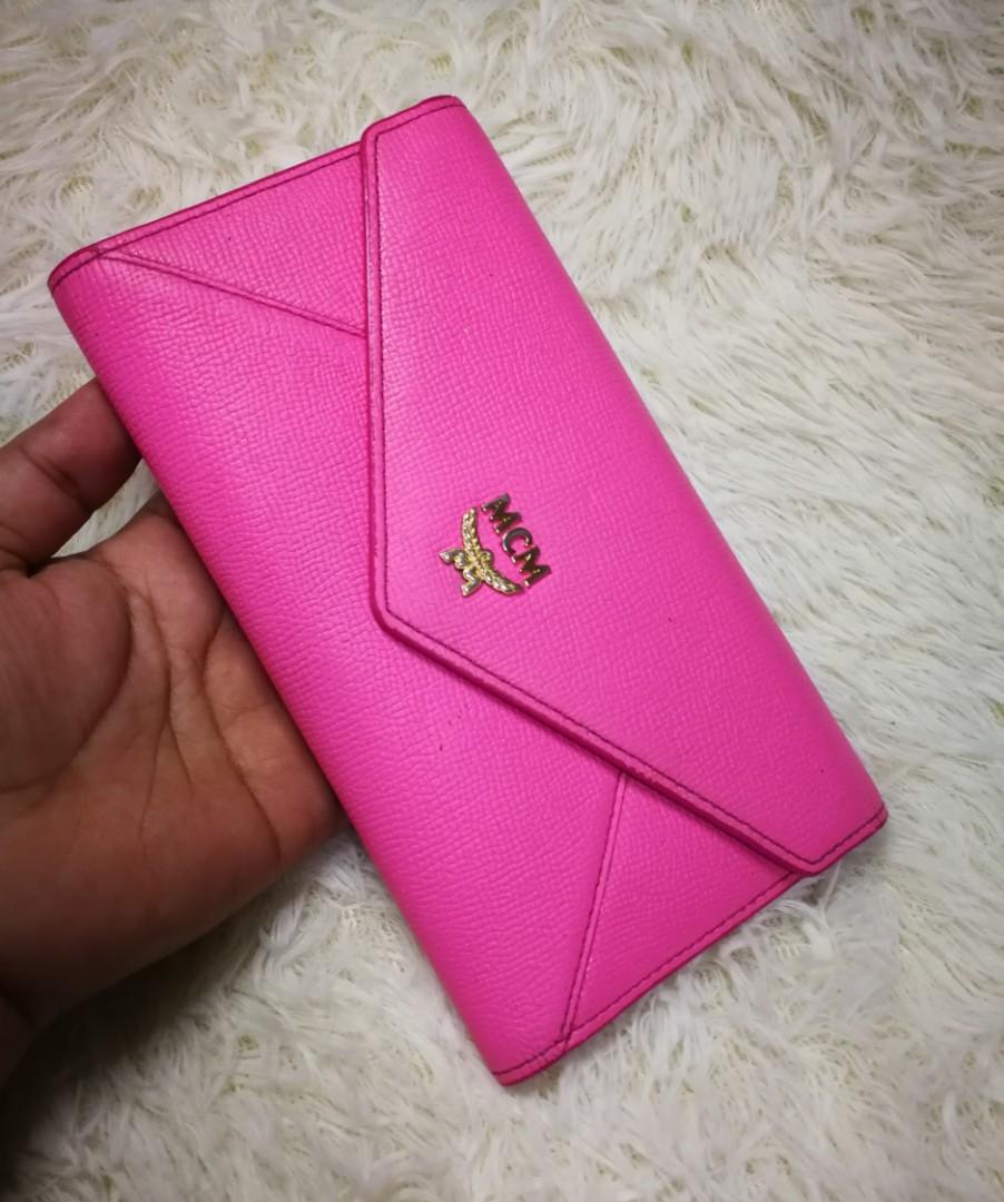 💯MCM Trifold Wallet (Category: Luxury Bags & Wallets) located in Cainta. Submitted by phengaying (Listing ID 1029957818, Image 2). Description: 💯Original or Moneyback | MCM Trifold Women's Wallet | Genuine Leather in Baby Pink Color | Gold-Tone Hardware | 12 Card Slot | Zip & Slip Bill Compartments | With Serial Code | MCM Signature Interior Lining | Preowned in 9/10 Condition | No Dust Bag/Box Flaw/s: Minor scuffs on leather and rubber lining.