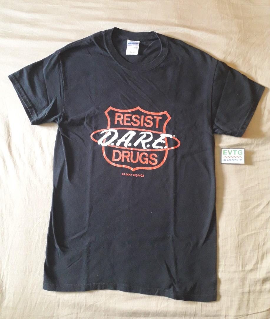 DARE Shield T-Shirt (Category: Tshirts & Polo Shirts ) located in Paranaque City. Submitted by evtg_supply (Listing ID 1031277239, Image 1). Description: D.A.R.E. to resist drugs t-shirt in black Brand : Gildan Made In : Nicaragua Size : Small (W: 16", L: 26") Condition : Very Good - no rips, no tears, no stain https://evtgsupply.wixsite.com/evtg.