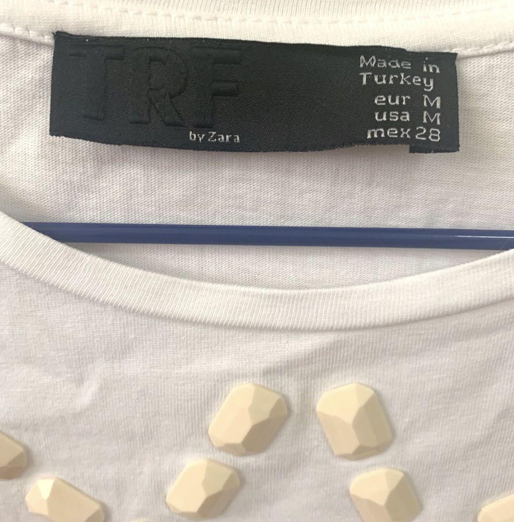 Zara White Shirt with Ceramic Detail (Category: Others Tops) located in San Pedro. Submitted by cammmv (Listing ID 1026299916, Image 2). Description: Well loved Zara White tee with Ceramic detail / best fits medium frames .