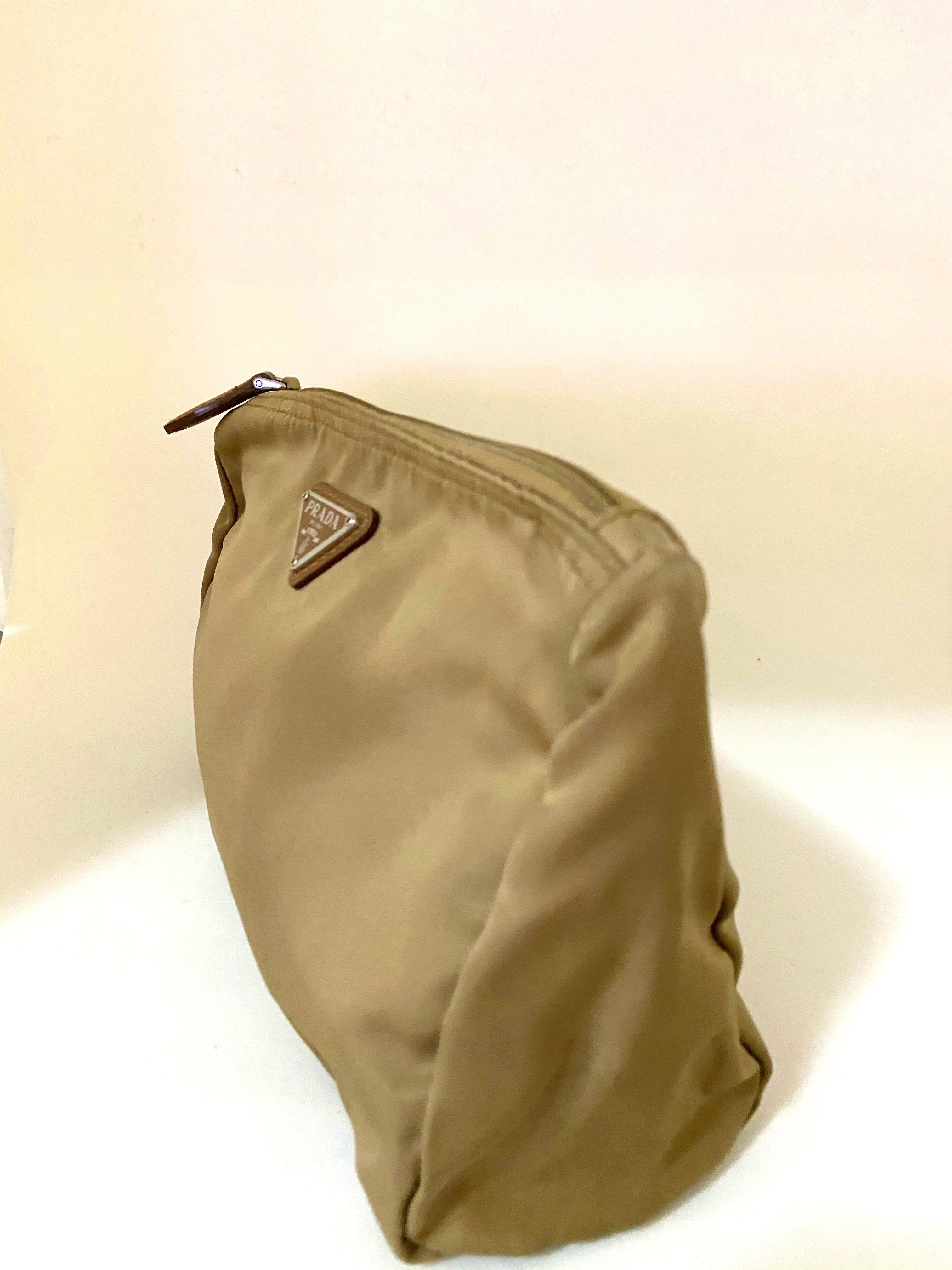 Prada Make Up Bag (Category: Luxury Bags & Wallets) located in Quezon City. Submitted by branded_luxe (Listing ID 1035166302, Image 3). Description: Authentic or Money Back Prada Make-Up Bag in beige/tan color. Used less than five times. No stains. Looks new. Retails for $400. Measures 13cm Height X 20cm Width. No inclusions. .