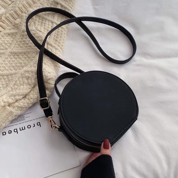 black round sling bag
